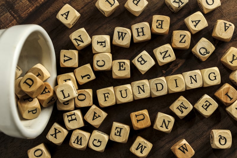 funding spelled out with letter dice
